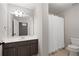 Bathroom with vanity, large mirror, decorative lighting, and a shower with curtain at 2620 Milford Ln, Alpharetta, GA 30009