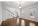 Elegant dining room with hardwood floors, stylish lighting, and access to the foyer at 2620 Milford Ln, Alpharetta, GA 30009
