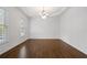 Spacious dining room boasting hardwood floors, decorative molding, and a stylish chandelier at 2620 Milford Ln, Alpharetta, GA 30009
