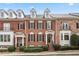 Charming brick townhome featuring symmetrical design, dormer windows, and inviting front entrances at 2620 Milford Ln, Alpharetta, GA 30009