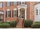 Close-up of a brick front entrance with well-manicured bushes and stairs leading to the front door at 2620 Milford Ln, Alpharetta, GA 30009