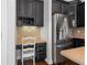 This kitchen features a dedicated workspace, stainless steel refrigerator, and stylish dark-stained cabinets at 2620 Milford Ln, Alpharetta, GA 30009