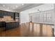 Open concept kitchen featuring a center island and flowing into a bright living area at 2620 Milford Ln, Alpharetta, GA 30009