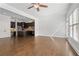 Expansive living area with a kitchen view, hardwood floors, large windows, and neutral wall colors at 2620 Milford Ln, Alpharetta, GA 30009