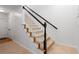 Carpeted staircase features black handrail with white spindles leading to the upper level at 2620 Milford Ln, Alpharetta, GA 30009