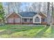 Charming brick home with a screened porch, manicured lawn, and mature trees in a quiet setting at 3075 Superior Dr, Dacula, GA 30019