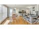 Bright kitchen featuring wood floors, bar seating, and modern lighting at 3075 Superior Dr, Dacula, GA 30019