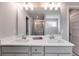 Elegant bathroom boasting dual sinks, stylish lighting, quartz countertop, and glass-enclosed shower at 804 Trestle Creek Ct, Temple, GA 30179