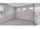 Bedroom with light gray walls, light carpet and windows at 804 Trestle Creek Ct, Temple, GA 30179