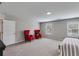 Spacious bedroom with two windows, two red accent chairs, and neutral-toned walls and carpeting at 804 Trestle Creek Ct, Temple, GA 30179
