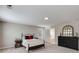 Cozy bedroom with queen bed, wooden accents, neutral walls, and a view into the ensuite bathroom at 804 Trestle Creek Ct, Temple, GA 30179