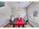 Bright dining room featuring wood floors, a modern chandelier, and a large window at 804 Trestle Creek Ct, Temple, GA 30179