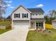 Charming two-story home features a two-car garage, a well-maintained lawn, and a welcoming front porch at 804 Trestle Creek Ct, Temple, GA 30179