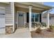 A welcoming front porch with chairs, stone accents, and a gray door at 804 Trestle Creek Ct, Temple, GA 30179