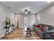 Spacious living room featuring wood floors, a comfortable sofa, and a ceiling fan at 804 Trestle Creek Ct, Temple, GA 30179