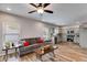 Open concept living room with wood floors, a modern sofa, and an adjacent kitchen at 804 Trestle Creek Ct, Temple, GA 30179