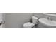 A well lit powder room features a pedestal sink and toilet at 804 Trestle Creek Ct, Temple, GA 30179