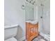 This bathroom features a wood vanity with a sink, a shower, and a toilet at 1090 Tanglewood Trl, Woodstock, GA 30189
