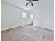 This bedroom features carpeted floors, neutral walls, a ceiling fan, and an ensuite bathroom at 1090 Tanglewood Trl, Woodstock, GA 30189