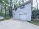 This home's exterior has white siding and an attached garage at 1090 Tanglewood Trl, Woodstock, GA 30189