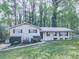 Charming single-story home featuring a well-manicured lawn and inviting curb appeal at 1090 Tanglewood Trl, Woodstock, GA 30189