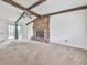 Bright living room features a brick fireplace, exposed beams, and sliding door access to the backyard at 1090 Tanglewood Trl, Woodstock, GA 30189