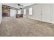 Bright living room with a brick fireplace, exposed beams, and ample natural light at 1090 Tanglewood Trl, Woodstock, GA 30189