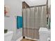 Cozy bathroom with a shower featuring a patterned curtain and tiled walls, plus a white vanity at 1965 Midway Rd, Douglasville, GA 30135