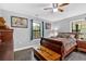 Comfortable bedroom with ample natural light, dark wood furniture and hardwood floors at 1965 Midway Rd, Douglasville, GA 30135