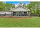 Charming home with a well maintained lawn, dark trim, and a covered front porch at 1965 Midway Rd, Douglasville, GA 30135