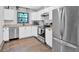 Modern kitchen with white cabinets, stainless steel appliances, and a view from the window above the sink at 1965 Midway Rd, Douglasville, GA 30135