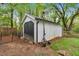 Exterior side view of a white wooden outbuilding or shed with black barn doors at 1965 Midway Rd, Douglasville, GA 30135