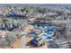 Scenic aerial shot of the neighborhood with lake, tennis courts, playground, and community center at 2112 Little River Dr, Suwanee, GA 30024