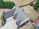 Aerial view of home showcases a well-maintained roof, fenced yard, landscaping, and paved driveway at 2112 Little River Dr, Suwanee, GA 30024