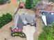 Aerial view of home with manicured lawn and landscaping, including driveway, backyard, and privacy fence at 2112 Little River Dr, Suwanee, GA 30024