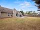 Large, grassy backyard features a patio, privacy fence, mature trees, and backs up to other homes at 2112 Little River Dr, Suwanee, GA 30024