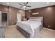 Spacious bedroom with a king bed, a ceiling fan, and a walk-in closet at 2112 Little River Dr, Suwanee, GA 30024