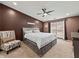 Cozy bedroom with a large bed, neutral tones, and comfortable seating area at 2112 Little River Dr, Suwanee, GA 30024