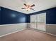 Cozy bedroom featuring a ceiling fan and wainscotting with ample natural light at 2112 Little River Dr, Suwanee, GA 30024