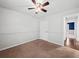 Bright bedroom with a ceiling fan, neutral carpet, and convenient access to other rooms at 2112 Little River Dr, Suwanee, GA 30024