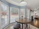 Bright breakfast nook with large windows overlooking the backyard and connecting to the kitchen at 2112 Little River Dr, Suwanee, GA 30024