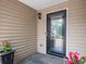 Covered front porch with tiled flooring and a glass front door, perfect for enjoying a warm day at 2112 Little River Dr, Suwanee, GA 30024