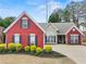 Charming single Gathering home with red brick and manicured landscaping in a well-maintained front yard at 2112 Little River Dr, Suwanee, GA 30024