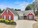 A single Gathering home with red brick, and manicured landscaping, with a two car garage and driveway at 2112 Little River Dr, Suwanee, GA 30024