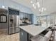 Modern kitchen featuring a large island with seating, stainless steel appliances, and ample counter space at 2112 Little River Dr, Suwanee, GA 30024