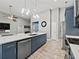 Bright, open kitchen featuring stainless steel appliances, island, and view into the living space at 2112 Little River Dr, Suwanee, GA 30024