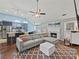 Open concept living room featuring hardwood floors, a fireplace, and modern furnishings at 2112 Little River Dr, Suwanee, GA 30024