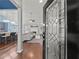 Inviting entryway with glass door leading to spacious living room with hardwood floors and fireplace at 2112 Little River Dr, Suwanee, GA 30024