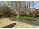 Landscaped backyard featuring green grass, mature trees, and neatly arranged mulch beds, creating a serene outdoor space at 3290 Winthrop Ne Cir, Marietta, GA 30067
