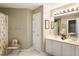 Light bathroom with a double sink vanity and a floral curtain in shower at 3290 Winthrop Ne Cir, Marietta, GA 30067